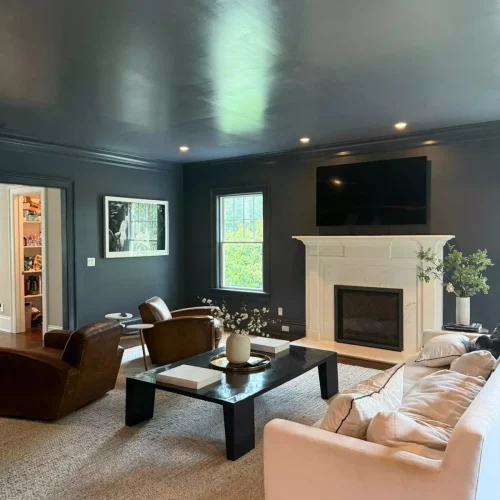 Spotless living room with fireplace and vacuumed beige sectional sofa